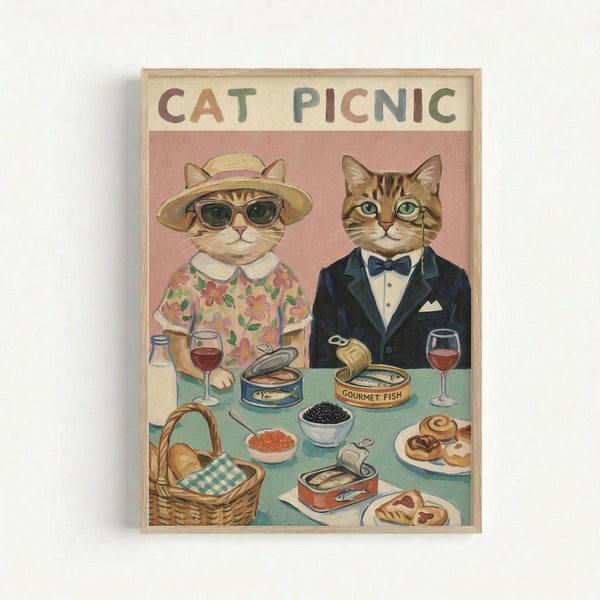 Framed vintage-style illustration of two anthropomorphic cats at a picnic table. The female cat wears a floral dress, sun hat, and sunglasses, while the male cat is dressed in a navy tuxedo with bow tie. The turquoise table displays gourmet foods including caviar, canned fish, wine glasses, pastries, and a wicker basket. The artwork has a whimsical mid-century aesthetic with muted pink background and CAT PICNIC text at the top in colorful letters.