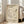 May include: Framed vintage-style exhibition poster featuring Picasso's minimalist line drawing of a dove carrying an olive branch, displayed on light wooden floors against white walls next to a beige upholstered sofa. The cream-colored poster shows black line art with English and Japanese text referencing a 1950 Museum of Modern Art exhibition.