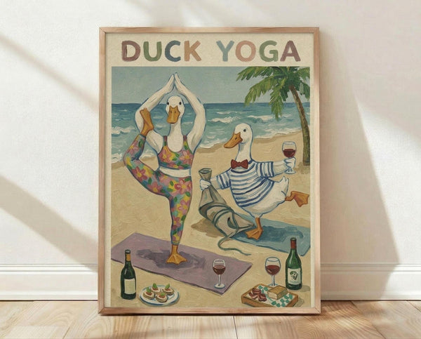 May include: Framed poster print leaning against white wall on light wood floor. Artwork shows two white ducks doing yoga poses on sandy beach - one in tree pose wearing colorful floral leggings on purple mat, another in seated position wearing striped shirt holding wine glass. Ocean waves and palm tree in background. Wine bottles, glasses, and appetizers scattered around beach scene. Vintage-style illustration in muted blues, greens, and warm tones with light wood frame.