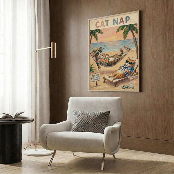 May include: Framed poster on wood-paneled wall showing cartoon cats relaxing at tropical beach - one sleeping in hammock wearing floral shirt, another on beach chair with striped shirt and cocktail, with palm trees and ocean sunset background. Modern beige armchair with geometric pillow, brass floor lamp, and dark round side table with open book in contemporary room setting.