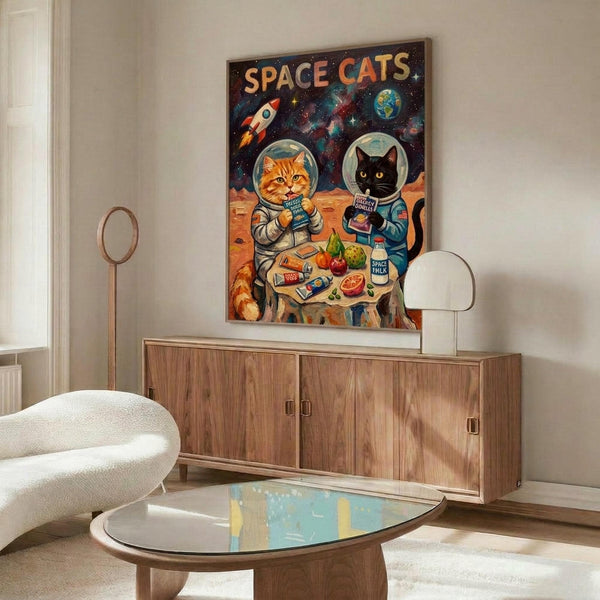 May include: Colorful poster showing two cats in astronaut suits sharing a meal at a table on an alien planet surface, with rockets and Earth visible in a starry background. Displayed above a mid-century modern walnut credenza in a bright living room with white curved chair and oval glass coffee table.