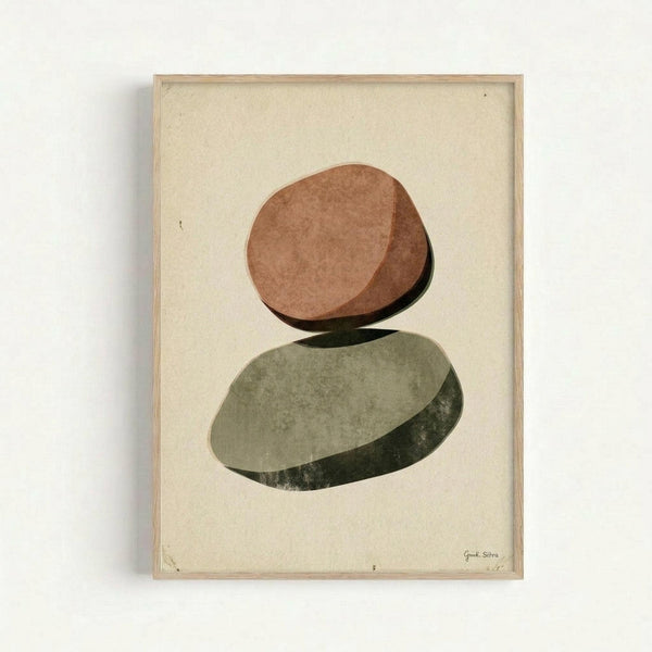 Minimalist art print featuring two balanced oval stones in warm terracotta and sage green colors with subtle shadows, displayed in a natural wood frame against a cream textured background. The stones appear to be delicately stacked, creating a zen-like composition with organic shapes and earthy tones.