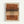Abstract artwork featuring horizontal brushstrokes in warm terracotta, ochre, brown, and beige tones with a central vertical column of small black polka dots creating a stippled pattern. The piece has an earthy, organic feel with painterly textures and is displayed in a light wooden frame against a white wall.
