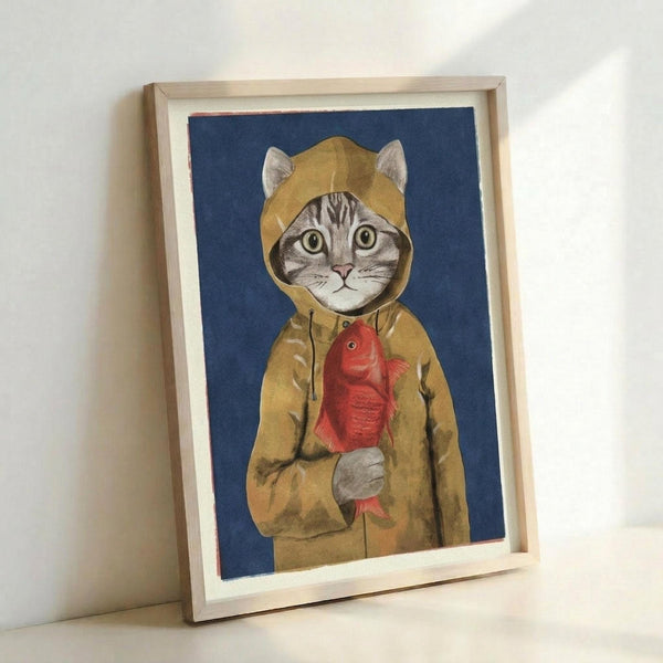 May include: Framed art print leaning against white wall showing tabby cat wearing yellow hooded raincoat holding red fish, illustrated in realistic style against deep blue background, displayed in light wood frame with white mat