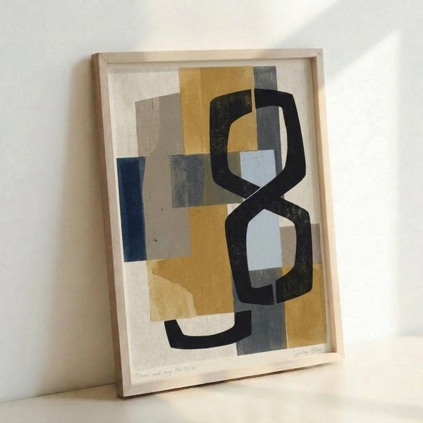 May include: Abstract geometric artwork in light wood frame leaning against white wall. Features overlapping shapes in mustard yellow, navy blue, gray, black and white with painterly textures. Bold black curved forms create flowing movement through layered rectangular color blocks. Signed print with visible artist signature at bottom.