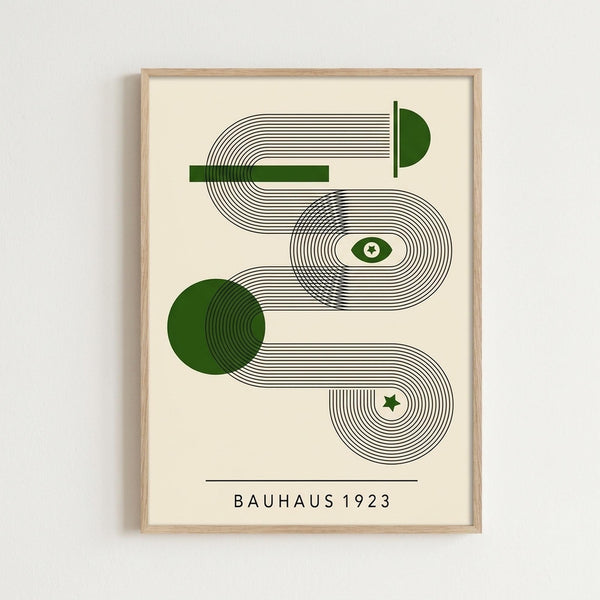 May include: Framed geometric art print with flowing black line patterns and green accents on cream background, displayed on white wall. Features abstract curved lines forming interconnected shapes with green circles, eye symbol, and star. Text reads "BAUHAUS 1923" below the design. Natural wood frame surrounds the minimalist modern artwork.