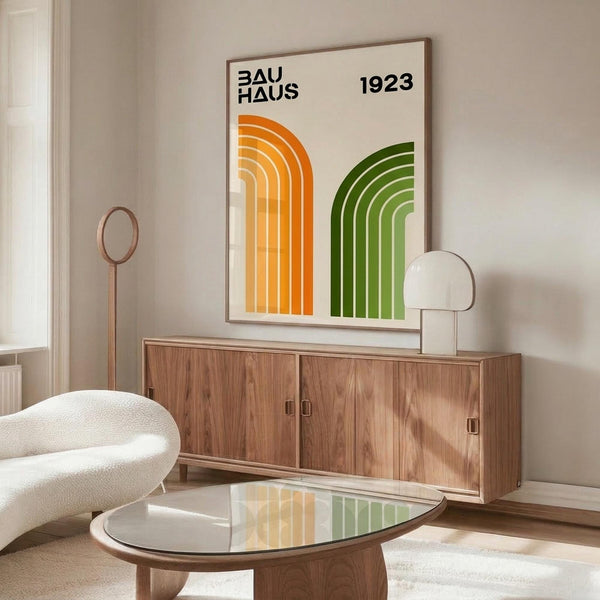 May include: Bauhaus-inspired geometric poster with orange and green rainbow arches on cream background, displayed above mid-century walnut credenza in minimalist living room with white curved chair, glass coffee table, and modern table lamp