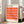 May include: Framed poster with geometric pink and orange cube pattern leaning against white wall next to beige sofa. Print features "bauhaus ausstellung" text at top and "WEIMAR JULI-SEPT 1923" at bottom on cream background. Light wood frame, bright natural lighting from nearby windows, hardwood floors with area rug visible.