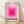 May include: Framed vintage-style poster with concentric pink squares in graduated shades from light to bright magenta, featuring black text reading "BAUHAUS-AUSSTELLUNG WEIMAR JULI - SEPT 1923" at bottom, displayed in light wood frame against white textured wall on wooden floor with soft natural lighting casting diagonal shadows