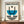 May include: Framed poster with geometric Bauhaus design featuring blue semicircle, black curved lines, striped circles and semicircle elements on cream background. Text reads "Bauhaus-Ausstellung Weimar Juli-Sept 1923" in black and blue letters. Wooden frame sits on mid-century credenza next to white ceramic vase and books in minimalist room with white walls and molding.