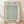 May include: Framed botanical poster print featuring intricate sage green willow leaf pattern on cream background, displayed in light wood frame against white textured wall on natural wood flooring with soft natural lighting and shadows