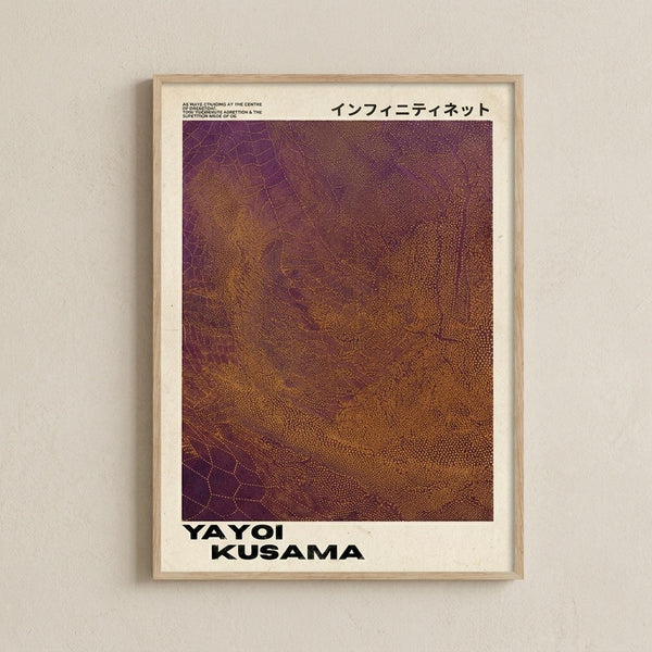 May include: Framed art poster with gradient dotted pattern in purple, burgundy, and golden brown tones, displayed on light beige wall. Features Japanese text at top, bold black text reading "YAYOI KUSAMA" at bottom, and small English text. Light wood frame with white matting creates clean, minimalist presentation against neutral wall background.