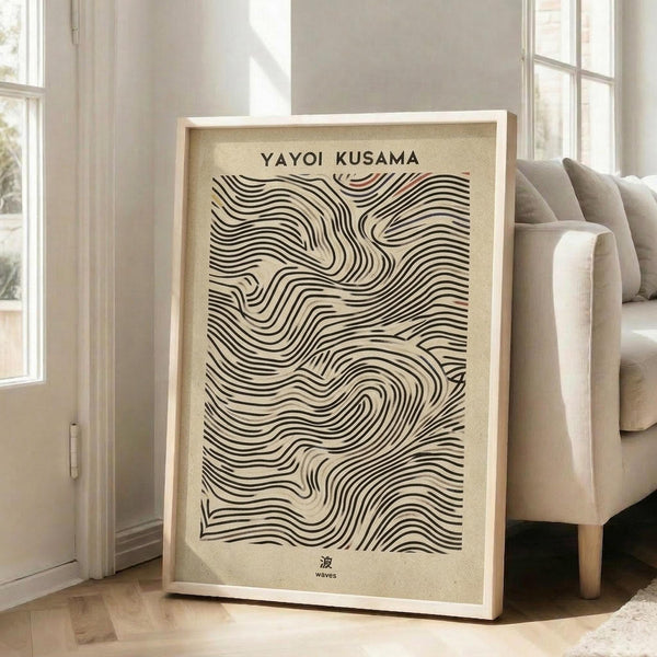 May include: Large framed poster with flowing black wavy lines creating an abstract topographical pattern on cream background, displayed against white wall near beige upholstered sofa in bright living room with tall windows and natural lighting