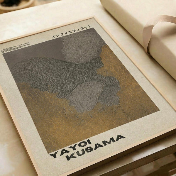 May include: Beige art print with textured dotted pattern in gray and golden brown tones, displayed on neutral paper with Japanese text at top, styled with rolled paper tubes on cream surface in soft natural lighting