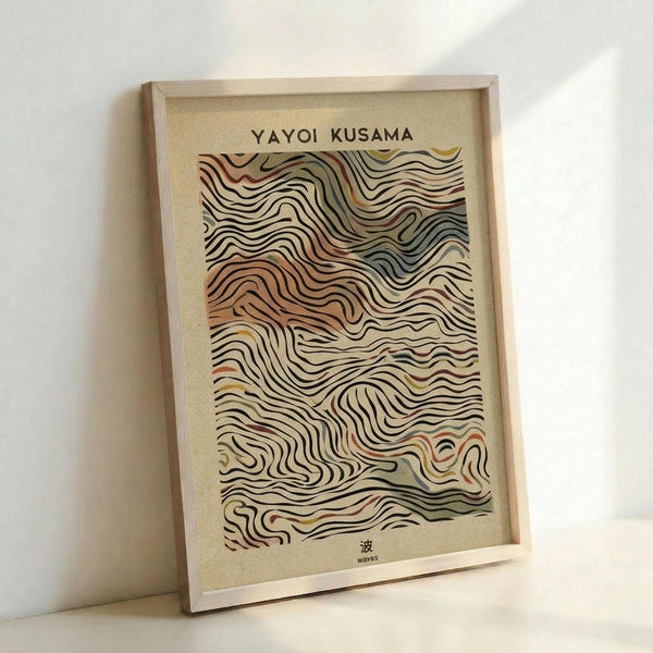 May include: Framed art print featuring flowing, wave-like contour lines in earth tones of brown, orange, and cream against a beige background. The abstract topographic pattern creates a mesmerizing ripple effect. Text reads "YAYOI KUSAMA" at top and includes Japanese character with "waves" translation below. Natural wood frame displayed against white wall, casting soft shadows.