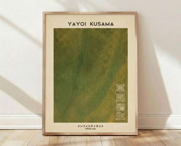 May include: Framed art print featuring green textured dot pattern inspired by Yayoi Kusama's infinity nets style, with Japanese text on cream background, displayed in light wood frame leaning against white wall on wooden floor with natural lighting and shadows
