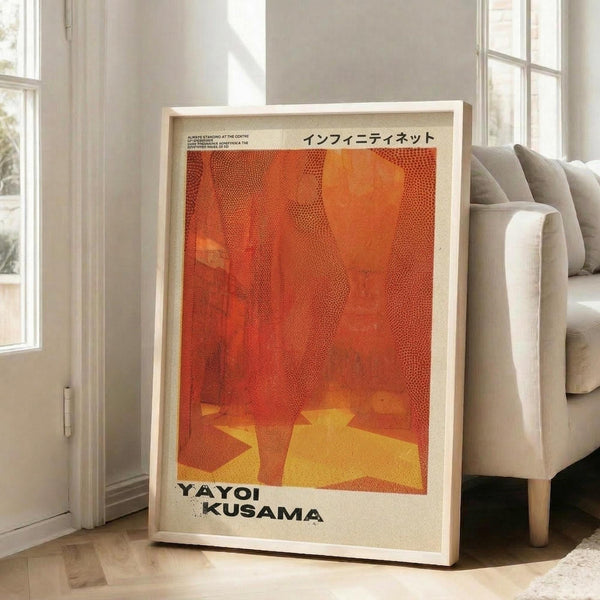 May include: Framed art print with orange and red abstract design featuring yellow geometric shapes and dotted patterns, displayed against white wall next to beige sofa in bright living room with large windows and natural lighting