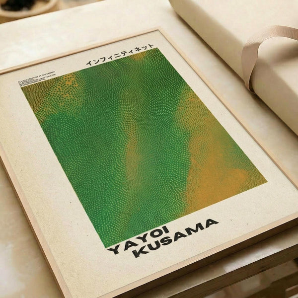 May include: Green and yellow gradient poster with dotted pattern texture displayed in white matted frame on neutral surface. The artwork features Kusama's signature infinity net style with small circular dots creating an organic, flowing pattern that transitions from vibrant green to warm yellow-orange tones.