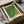 May include: Green and yellow dotted abstract art print in wooden frame, packed in cardboard box with tissue paper wrapping. The artwork features Kusama's signature infinity net pattern with small repetitive dots creating a textured surface that transitions from bright green to golden yellow tones.