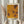 May include: Framed poster with yellow and orange abstract dotted pattern artwork in light wood frame, displayed on neutral wall beside dried pampas grass and beige fabric items with natural lighting creating soft shadows