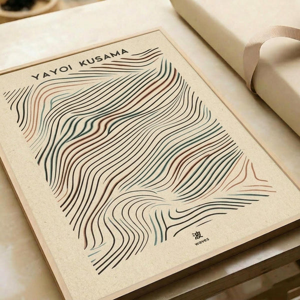 Modern abstract art print featuring flowing wave-like lines in cream, brown, and teal colors on beige textured paper. The organic curved lines create a dynamic pattern resembling topographical contours or wood grain. Print is displayed flat on a neutral surface next to rolled paper tubes, showing the artwork's clean minimalist aesthetic and natural color palette.