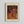 May include: Framed art print displaying abstract composition with orange background, purple polka dots and circular shapes, intricate dotted textures throughout. Features "YAYOI KUSAMA" text at top and Japanese characters on right side, with "infinity nets" subtitle at bottom. Light wood frame with cream matting, mounted on white wall.