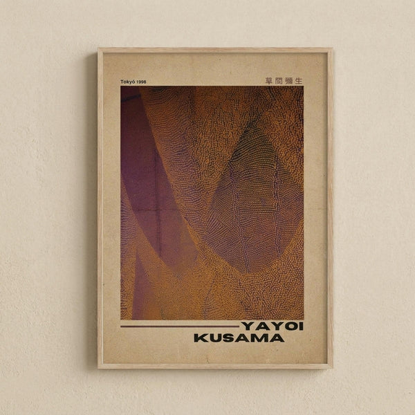 May include: Framed vintage-style art print hanging on cream wall featuring abstract organic forms in warm brown, orange and purple tones with dotted texture patterns. Text reads "Tokyo 1998" and "YAYOI KUSAMA" in black letters. Light wood frame with beige matting creates museum poster aesthetic.