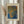 May include: Framed art print displayed on neutral wall next to dried pampas grass in glass vase. Print features abstract dotted pattern in blue, orange and yellow tones with Japanese text. Light wood frame with cream matting, soft natural lighting, minimalist home decor setting.