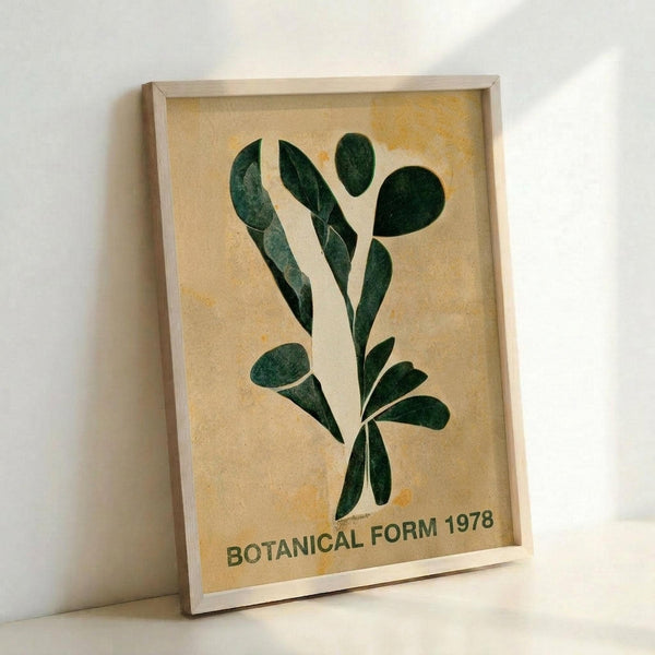 May include: Framed botanical print leaning against white wall corner. Artwork features abstract green leaf shapes arranged vertically on aged cream background with yellow staining. Text reads "BOTANICAL FORM 1978" at bottom. Light wood frame casts subtle shadow on wall. Vintage-inspired minimalist design with organic curved forms.