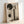May include: Framed abstract art print leaning against white wall, featuring geometric black circles and vertical rectangular strips in muted earth tones, with silhouetted evergreen trees at bottom, displayed in light wood frame on neutral surface with soft natural lighting