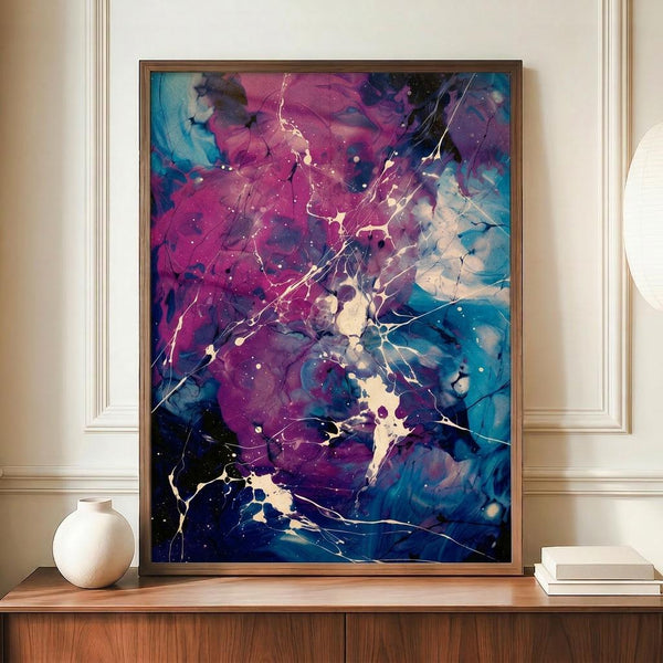 May include: Framed abstract art print featuring vibrant purple and blue fluid paint splatters with white lightning-like cracks and golden accents, displayed on wooden sideboard next to cream ceramic vase and stacked books in elegant room with cream wainscoting walls.