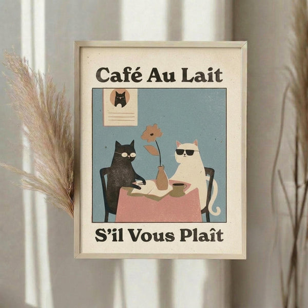 May include: Framed vintage-style poster featuring two cats sitting at a small table with coffee cups and a flower in a vase. A black cat and white cat wearing sunglasses are illustrated in muted colors against a blue-green background. French text reads "Café Au Lait" and "S'il Vous Plaît" in dark letters on cream matting. Natural wood frame displayed on white windowsill next to dried pampas grass stems with soft curtains in background.