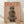 May include: Framed poster print featuring a whippet dog wearing a herringbone newsboy cap and layered fuzzy brown scarves against a warm peach background, with "DOGUE" text in orange letters at top, displayed on light wood flooring against white walls with natural lighting creating soft shadows