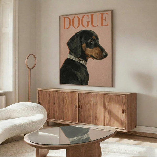 May include: Framed poster on wall above wooden credenza featuring black and tan dachshund wearing pearl necklace on pink background with "DOGUE" text in orange letters, styled like fashion magazine cover. Modern living room setting with white upholstered chair, round glass coffee table, and floor lamp.