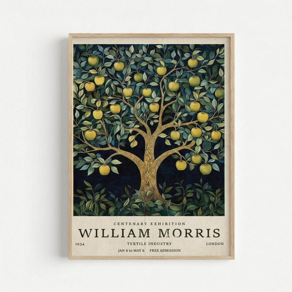 Framed vintage exhibition poster featuring an ornate apple tree with golden fruit against a dark navy background. The tree has decorative carved-style trunk details and lush green foliage with yellow apples throughout the branches. Below the artwork is cream-colored text reading "Centenary Exhibition William Morris" with exhibition details including "1934 Textile Industry London Jan 6 to May 6 Free Admission." The poster is displayed in a light wooden frame against a white wall.