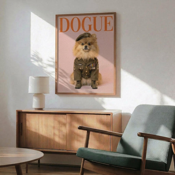May include: Framed poster print featuring a fluffy Pomeranian dog dressed in olive green military uniform with cap, medals and boots against pink background, displayed on white wall above wooden sideboard with ceramic lamp, next to sage green mid-century modern armchair in naturally lit room