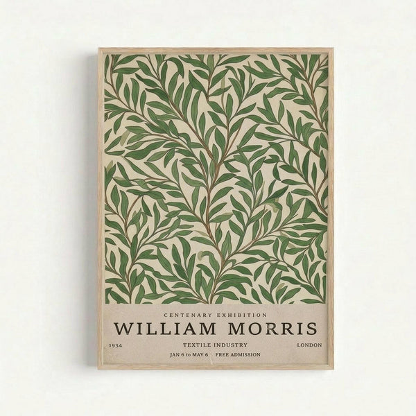 May include: Framed botanical poster with green leafy pattern on cream background, displayed on white wall. Features vintage exhibition text reading "William Morris Centenary Exhibition 1934 Textile Industry London Jan 6 to May 6 Free Admission" at bottom. Light wood frame surrounds the artwork showing flowing, intertwining branches and foliage in an Arts and Crafts style design.