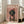 May include: Framed poster featuring a dachshund wearing a pink beret and floral outfit on pink background with "DOGUE" text at top, displayed in bright living room with beige sofa, large windows, and light wooden floors