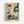 Colorful vintage-style botanical illustration poster in light wood frame against white wall. Features stylized flowers, leaves and plants in navy blue, coral red, mustard yellow, and teal green on cream background. Art includes daisy-like blooms, abstract foliage with polka dot patterns, and decorative botanical elements in mid-century modern design. Text reads "OSAKA '82" and "FLOWER MARKET" at bottom in sans-serif font.