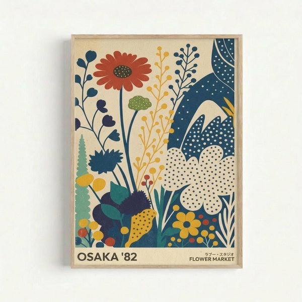 Colorful vintage-style botanical illustration poster in light wood frame against white wall. Features stylized flowers, leaves and plants in navy blue, coral red, mustard yellow, and teal green on cream background. Art includes daisy-like blooms, abstract foliage with polka dot patterns, and decorative botanical elements in mid-century modern design. Text reads "OSAKA '82" and "FLOWER MARKET" at bottom in sans-serif font.
