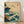 May include: Framed Japanese-inspired artwork featuring dramatic teal and dark blue ocean waves with white foam crashing against brown rocky cliffs. Four black birds fly across a cream-colored sky above a distant sailing ship. The print has traditional Asian calligraphy in a red seal stamp and is displayed in a light wood frame against white walls on wooden flooring with soft natural lighting.