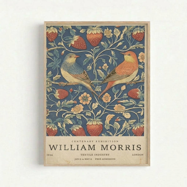 Framed poster featuring William Morris's Strawberry Thief pattern with two birds perched among strawberry vines on a deep blue background. The decorative design shows red strawberries, green leaves, and cream-colored flowers in an intricate Arts and Crafts style. Below the artwork is text reading "Centenary Exhibition William Morris" with exhibition details including "1934 Textile Industry London Jan 6 to May 6 Free Admission" on a cream background.