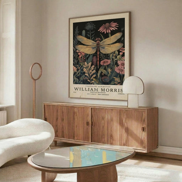 May include: Framed vintage-style botanical poster featuring golden dragonfly with detailed wings surrounded by pink flowers and green foliage on dark background, displayed above mid-century modern walnut credenza with brass handles in minimalist living room with cream walls, white upholstered chair, and oval glass coffee table