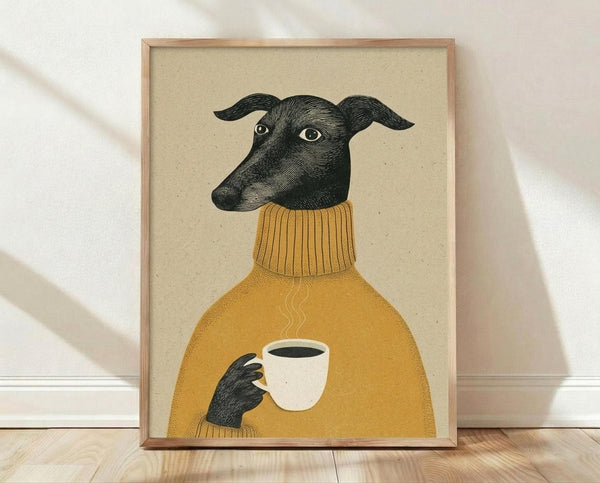 May include: Framed poster print leaning against white wall on light wood floor. Shows illustration of black greyhound dog wearing mustard yellow ribbed turtleneck sweater, holding white coffee cup with steam rising. Dog has alert ears and bright eyes against cream textured background. Natural wood frame, soft shadows from window light.
