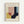 May include: Framed poster with light wood frame hanging on white wall. Features geometric abstract design with overlapping shapes in muted colors including yellow, coral pink, sage green, navy blue, and cream. Text reads "BAUHAUS" at top and "Exhibition Art 1919" at bottom on cream background.