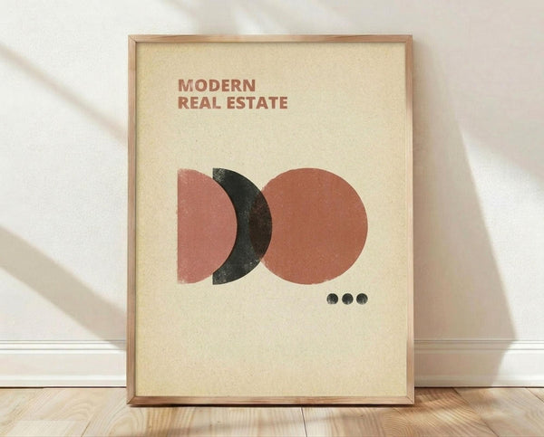 May include: Framed poster with cream background featuring abstract geometric design of overlapping circles in coral pink, rust orange, and dark charcoal colors with three small black dots below. Natural wood frame displayed on light wooden floor against white wall with soft shadows.