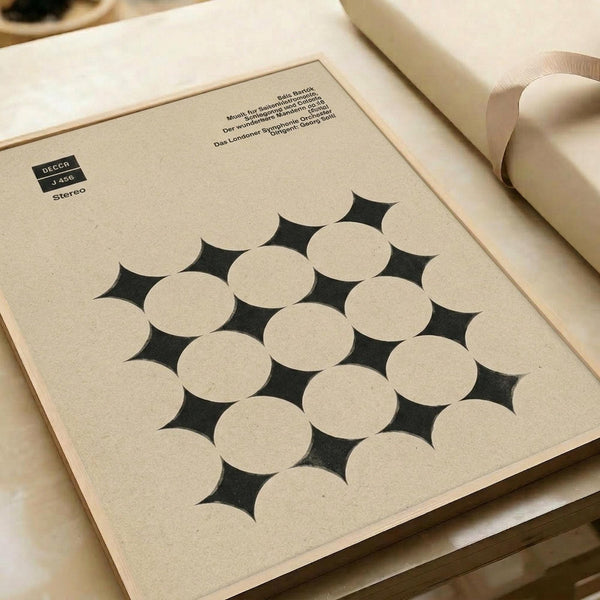 Vintage classical music album cover with geometric pattern of overlapping cream circles creating diamond-shaped gaps on beige background. Features Decca record label branding and German text at top. The minimalist design shows stereo catalog number and conductor information. Photographed at an angle on white surface with soft lighting and partial view of white ribbon.