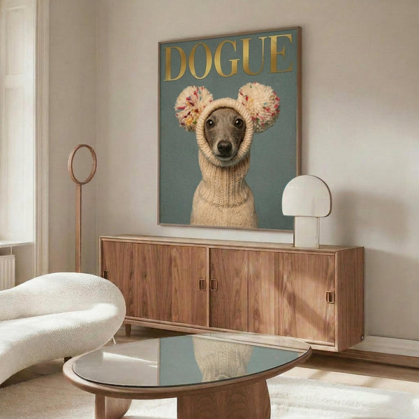 May include: Framed poster featuring an Italian Greyhound wearing a cream knit sweater with colorful pom-pom ear warmers against a teal background with "DOGUE" in gold lettering, displayed on a walnut credenza in a modern living room with white curved chair, glass coffee table, and white table lamp