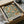 May include: Vintage botanical poster featuring orange fruit branches with green leaves and small yellow flowers on cream background, displayed in black frame inside cardboard shipping box with protective tissue paper wrapping