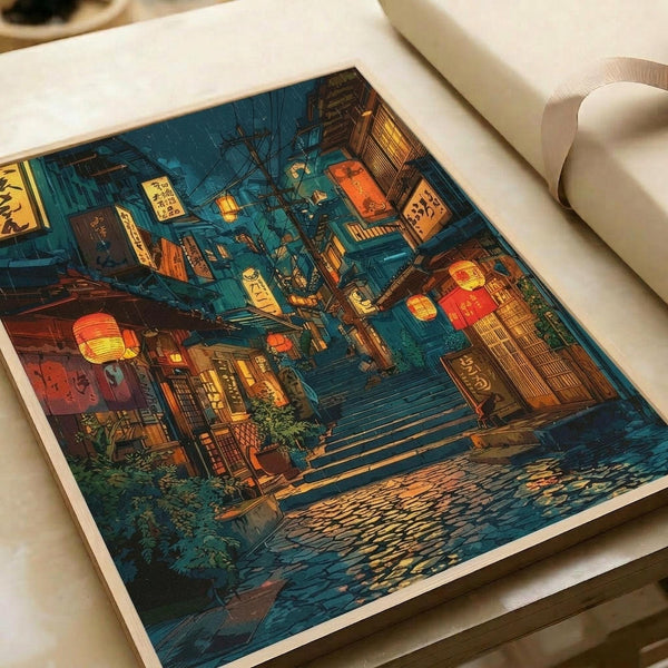 May include: Art print displayed on white surface showing Japanese street scene at night in rain. Narrow alley with wooden stairs, traditional buildings, glowing red and yellow paper lanterns, neon signs with Japanese text. Deep blue and teal tones with warm orange lighting. Wet pavement reflects lights. Print has white border, appears medium-sized next to rolled white papers.